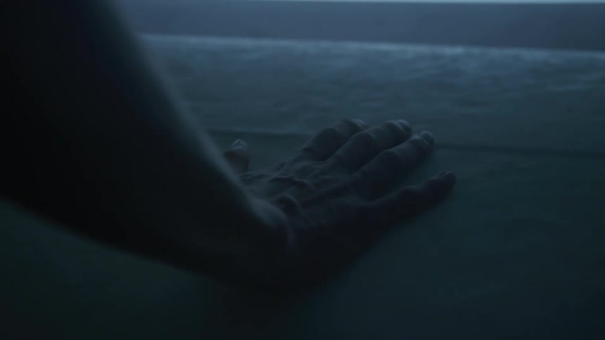 Close up of a hand gently touching a textured surface