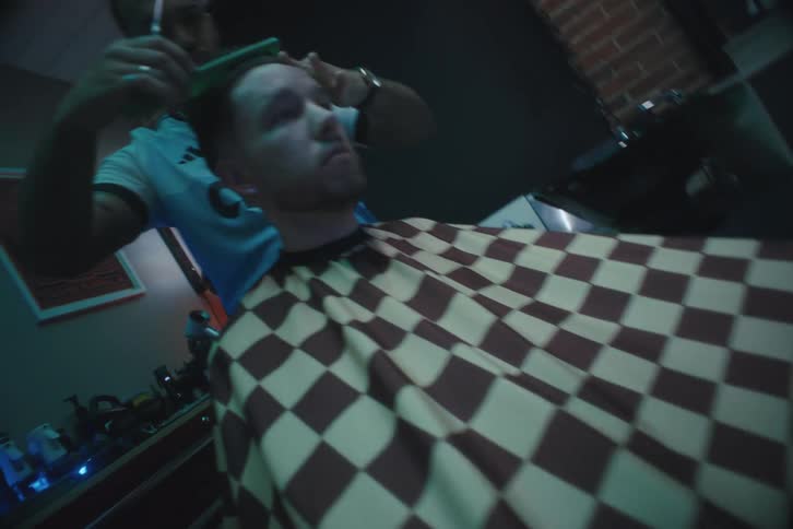 A barber is cutting someones hair