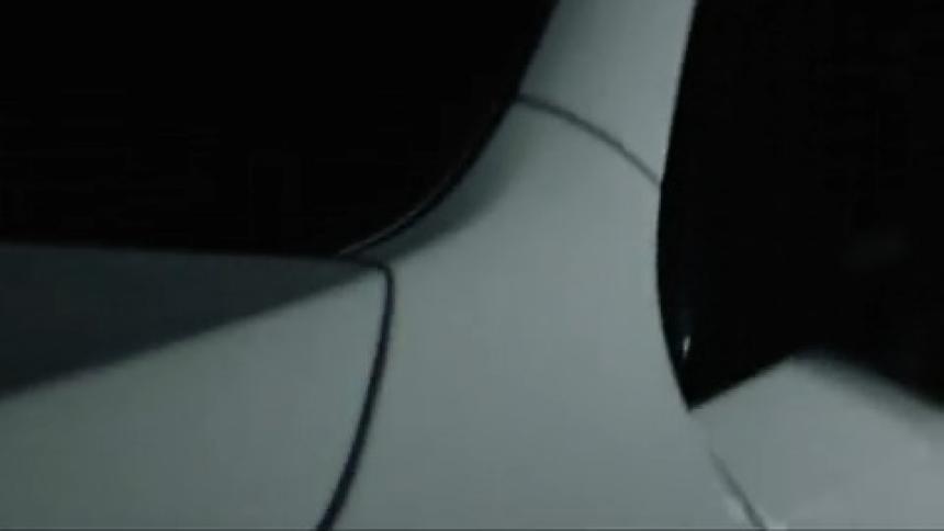 White vehicle with dark windows reflects bright light