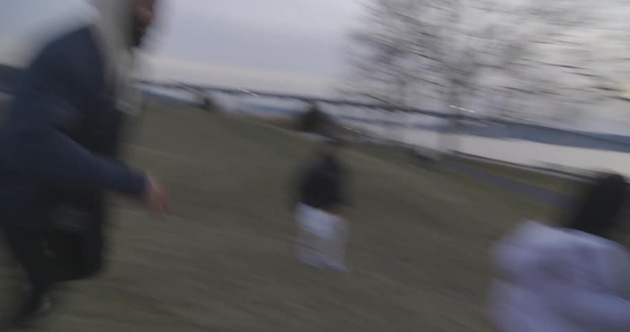 Father and daughter running outside on a clear day