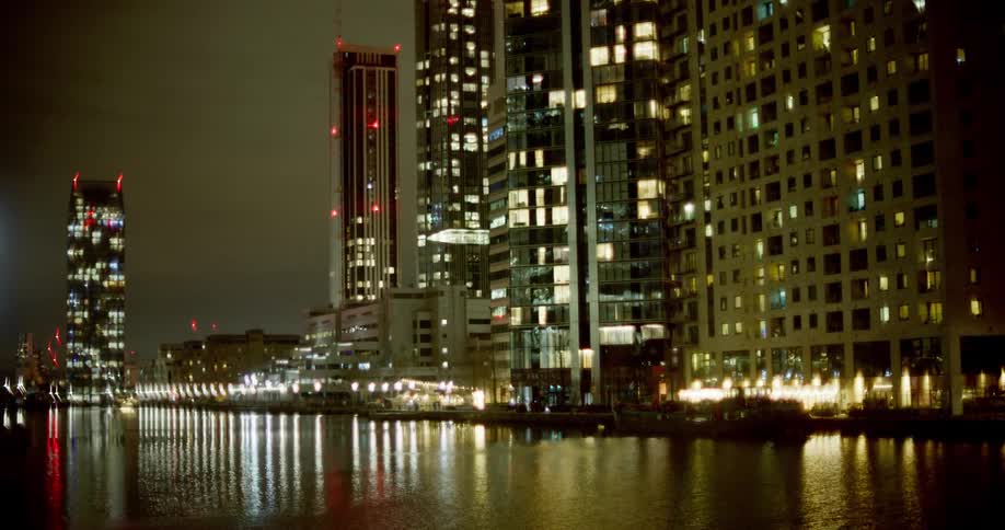 Night cityscape with lights reflected in foreground water