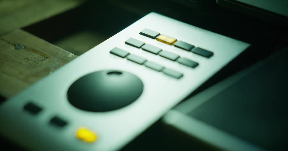 Close up of a hand adjusting a dial on an electronic device