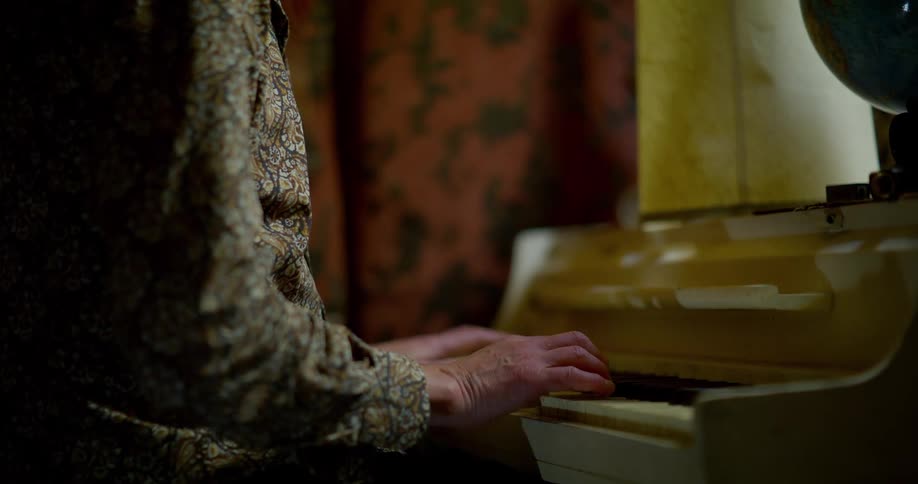 A person plays an old fashioned keyboard