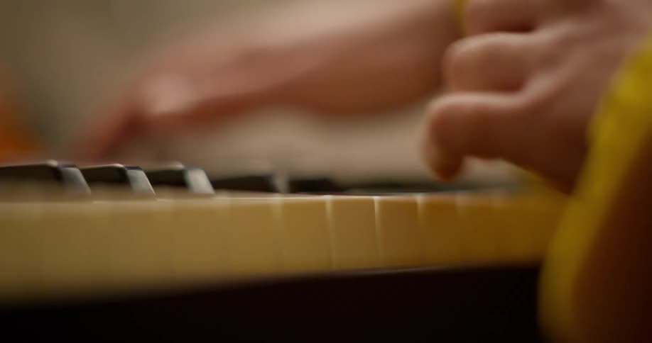 Close up of the hands of a musician playing a keyboard