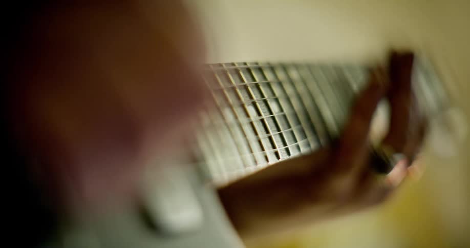 Close up of a person playing a guitar