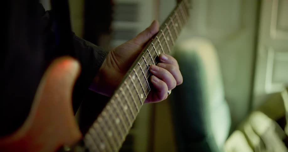 A hand playing guitar