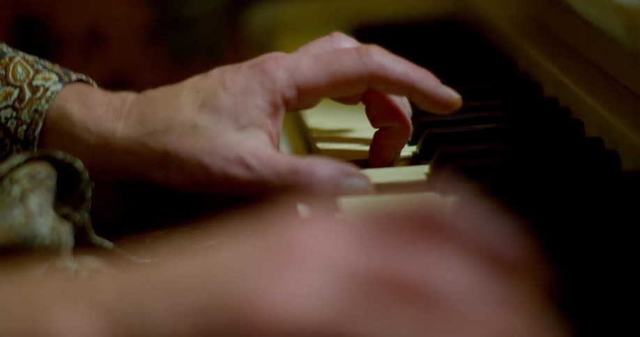 Close up of hands playing the piano
