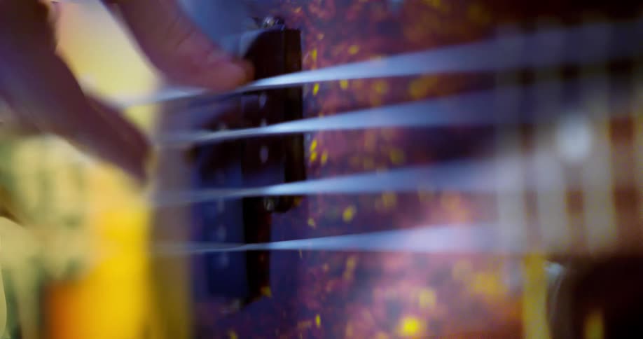 Timelapse close up of fingers playing an electric bass guitar