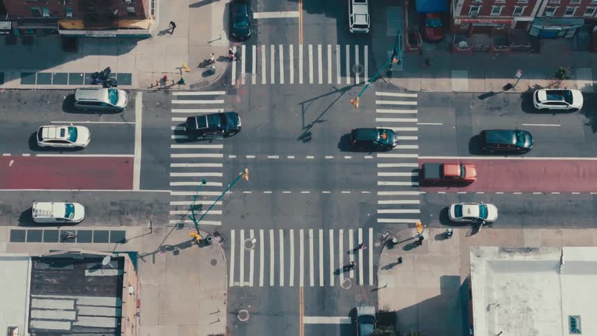 Public road in a metropolis with vehicles and pedestrians during the day