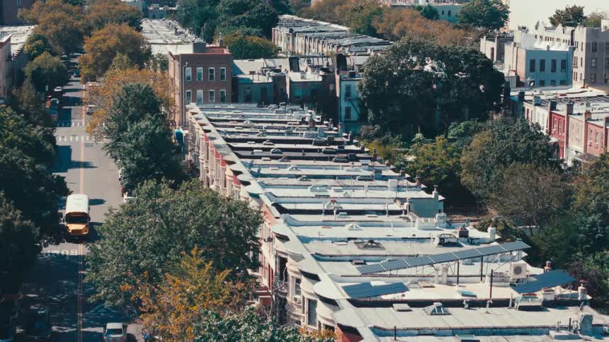 Traffic moves through a dense suburban area