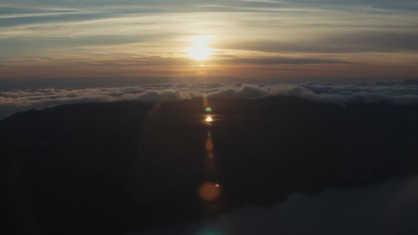 Aerial landscape of a peninsula with clouds and sunrise on the horizon