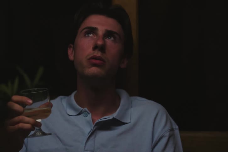 Two men at a table drinking and talking