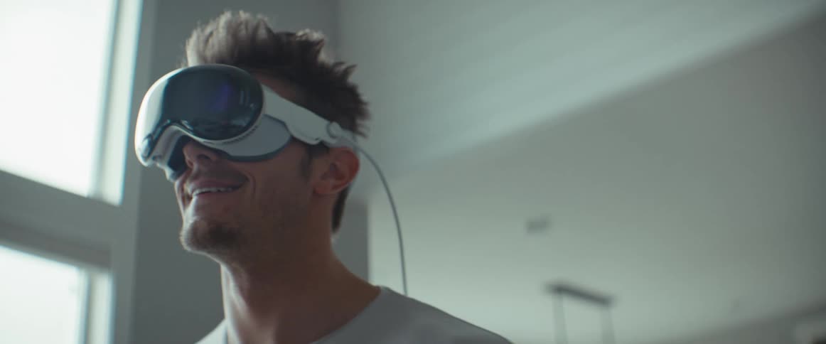 Man standing walking around the house while using virtual reality glasses
