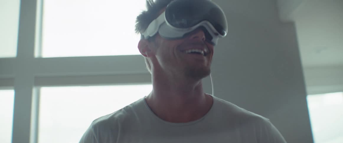 Man at home smiles while having a conversation via virtual reality headset