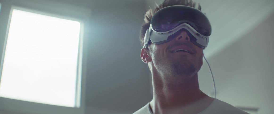A man smiles while using a virtual reality headset
