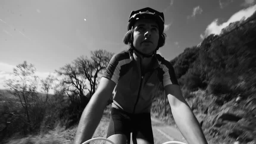 Selfie of a young man riding a mountain bike in a natural environment