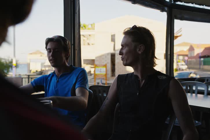 Friendly men sitting in a bar talking