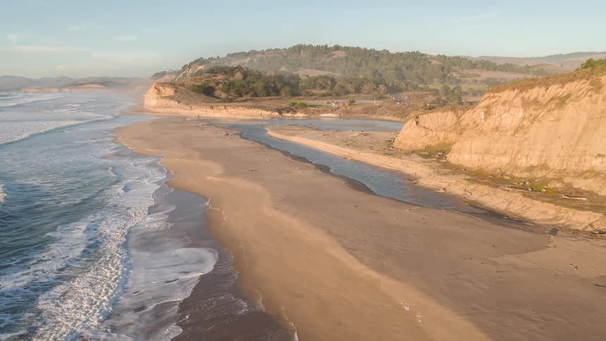 Waves crash against a beach