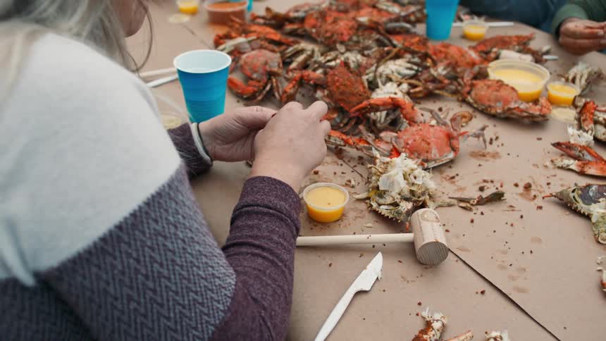 A group of people eat seafood at an outdoor restaurant
