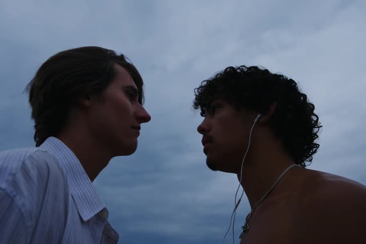 Two young men share a romantic moment on a beach