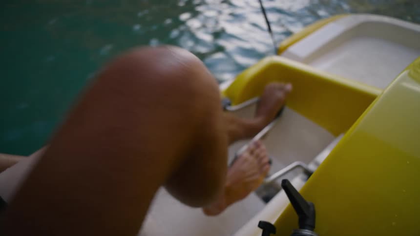 Man using a paddle boat smiling having a good time