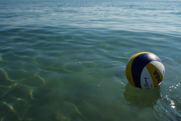Volleyball ball in the beach sea