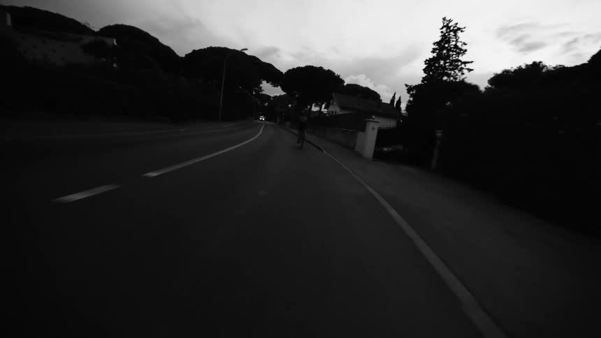 Point of view of two people cycling on a street with vehicle traffic during the day