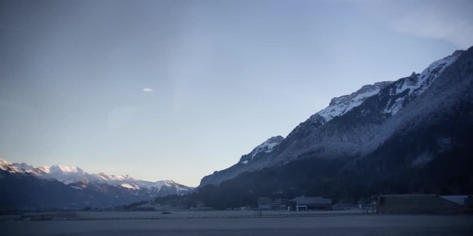 Landscape overlooking snowcovered mountains in a morning