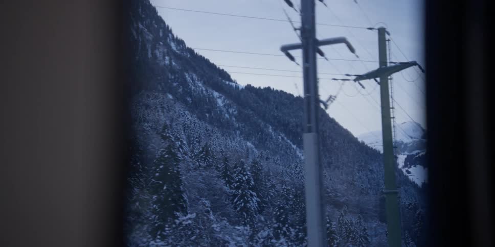 The train passes the snow covered mountain