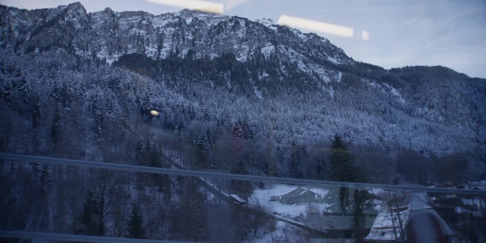 A snowy landscape seen through a train window