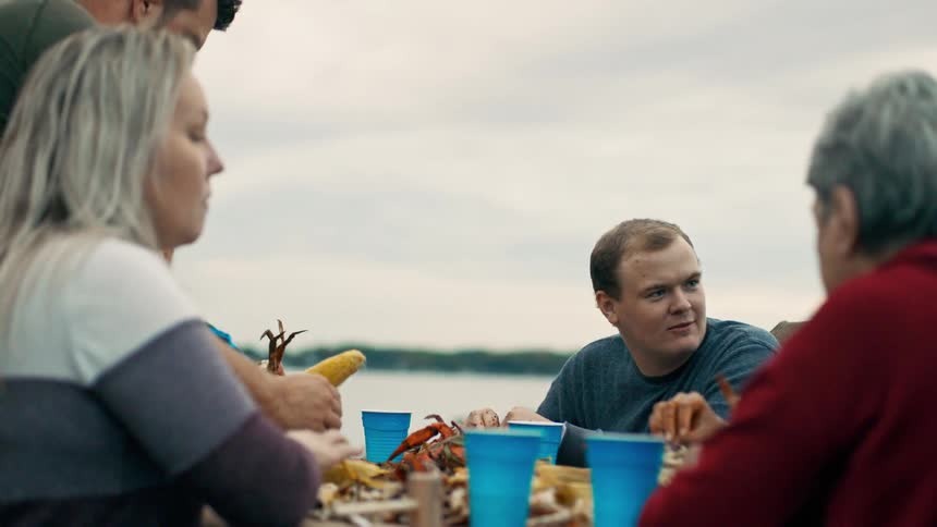 A group of people eating food outdoors