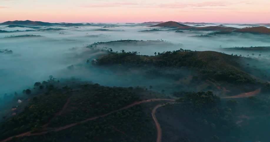 Aerial view of mountain roads surrounded by dense fog