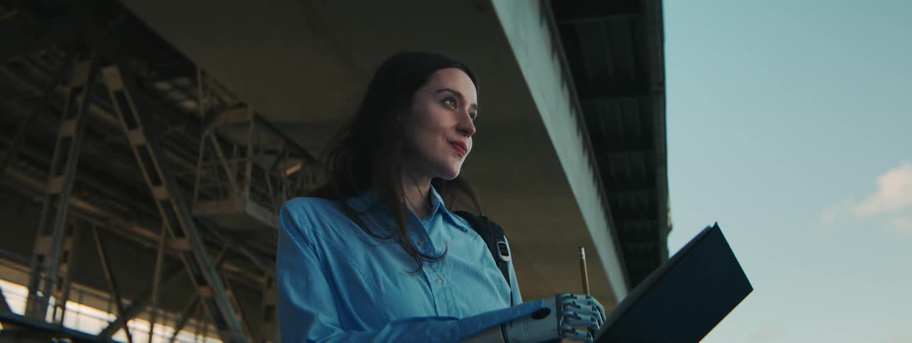 Young woman in an outdoor landscape drawing with one of his robotic arms
