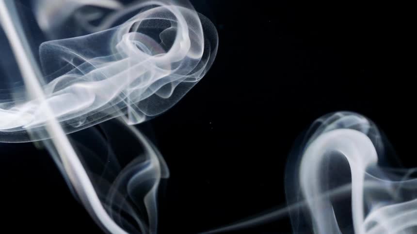Some white smoke and heading upwards on a black background
