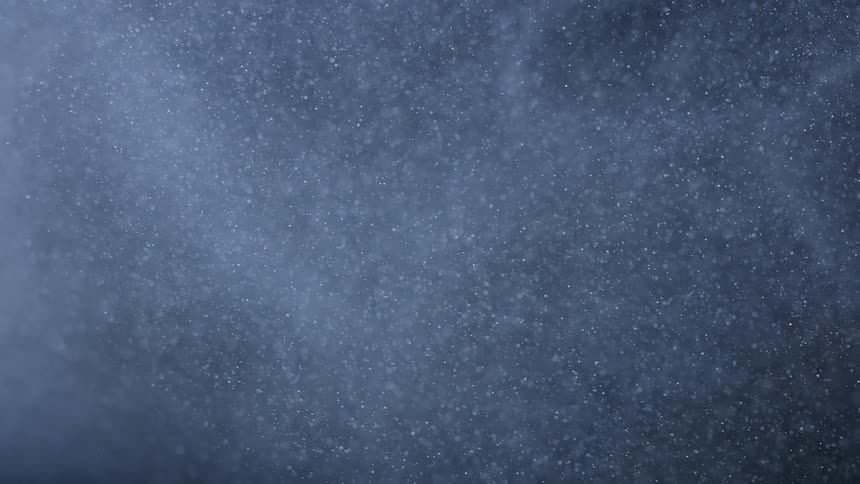 Lots of white particles going left and up in a white colored environment