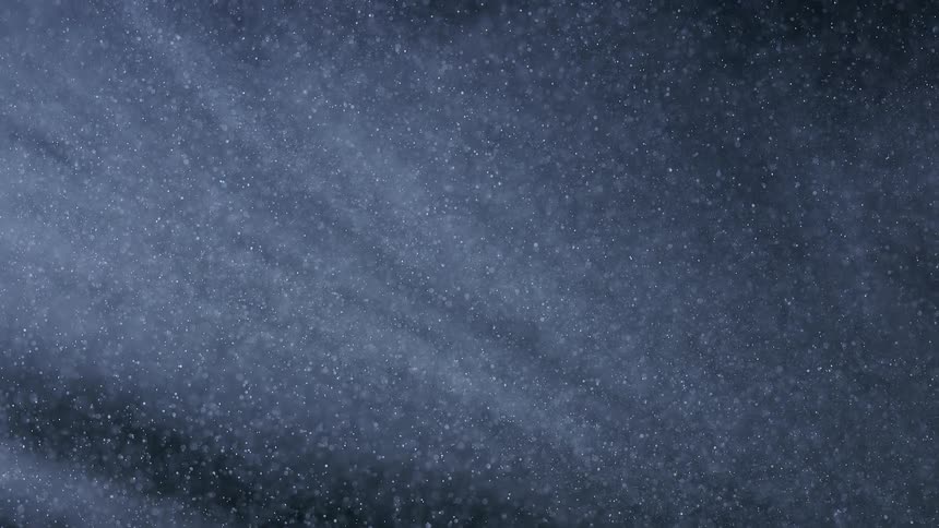 Extreme closeup dense dust falling in slow motion