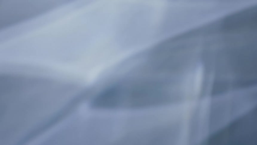 Extreme closeup on an abstract slowmotion reflection on a black background