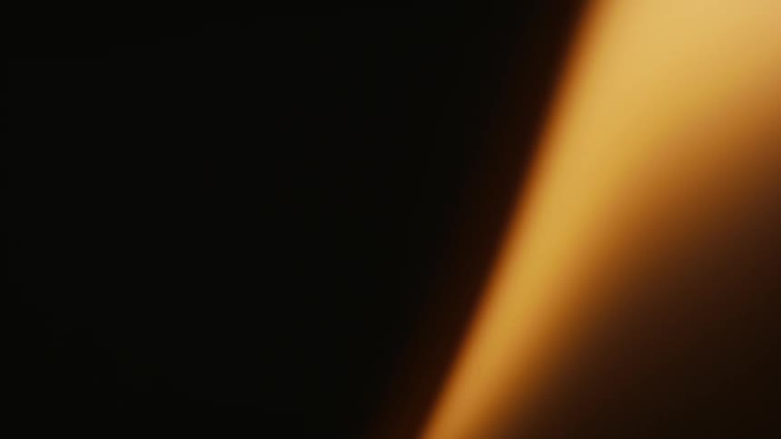 Extreme closeup of an abstract golden beam on black background