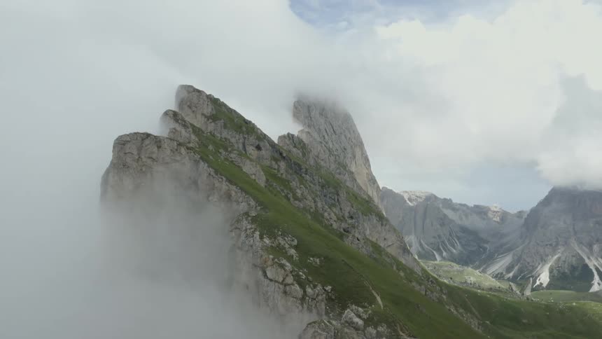 The clouds sit on the mountain top