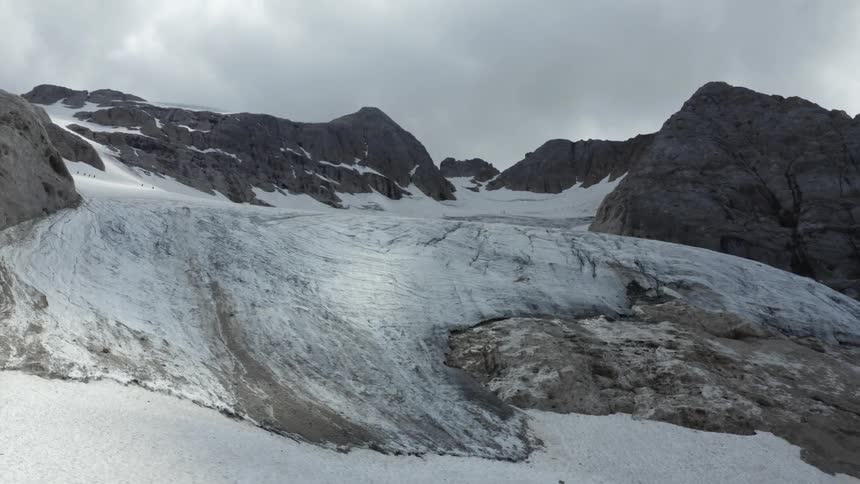 A glacier fills a mountain valley