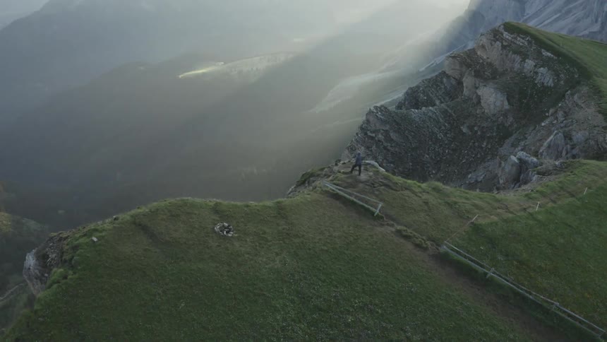 Panorama area of a man on a mountain cliff