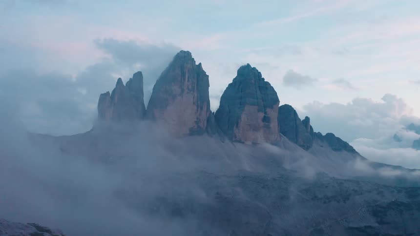 Haze moves past a giant mountain range