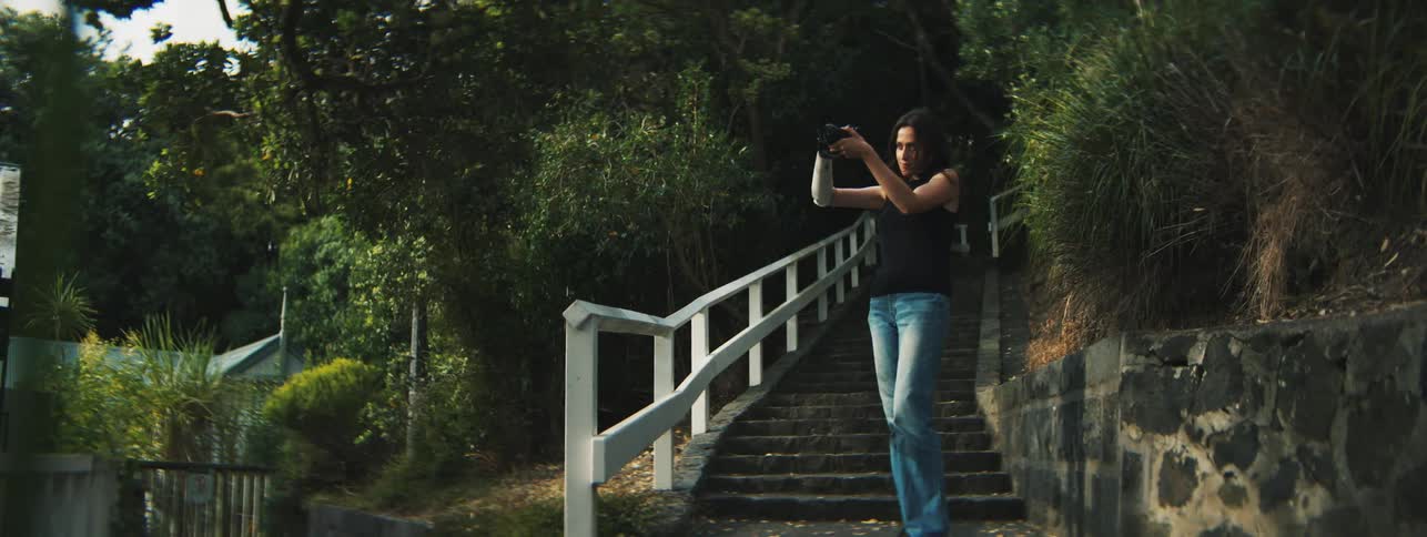 A woman is taking photographs of nature
