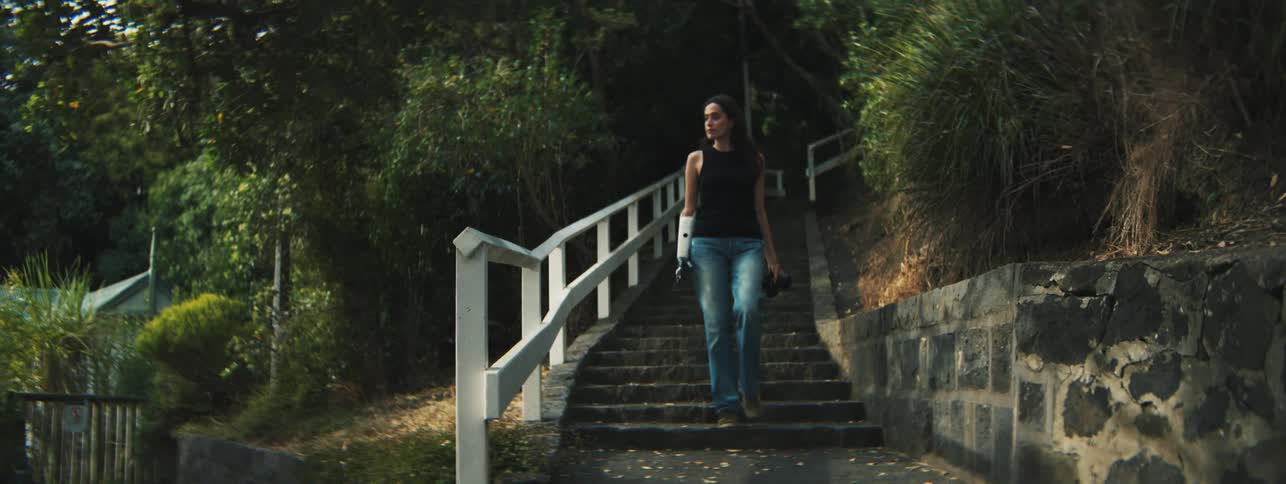 A cli of a lady coming down the staircase