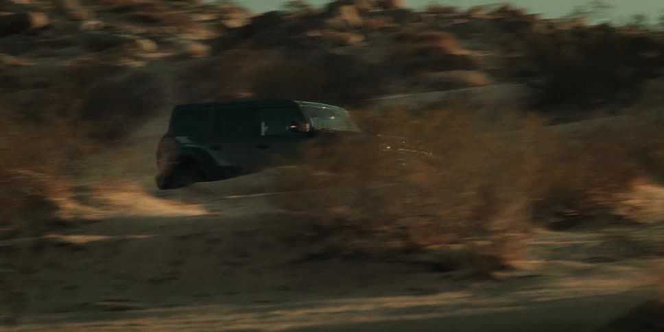 Car driving fast through a deserted landscape