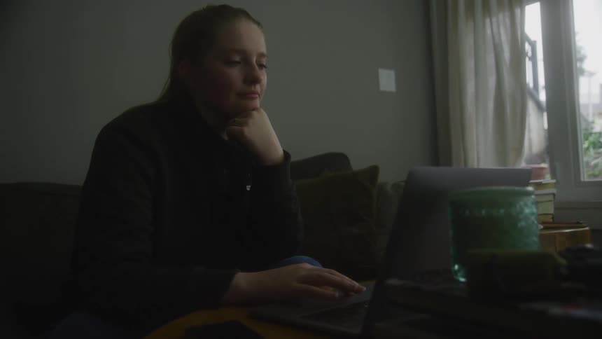 A woman is using her laptop