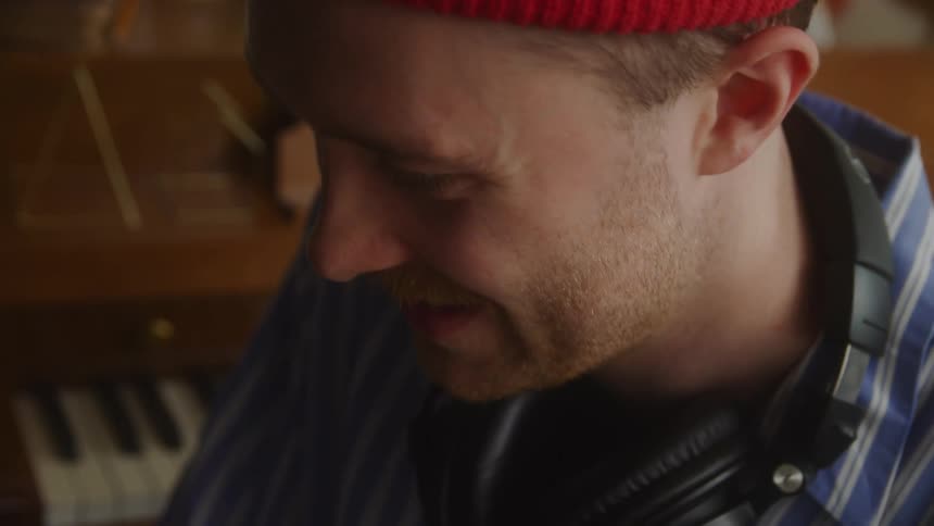 Side portrait of a smiling man indoors