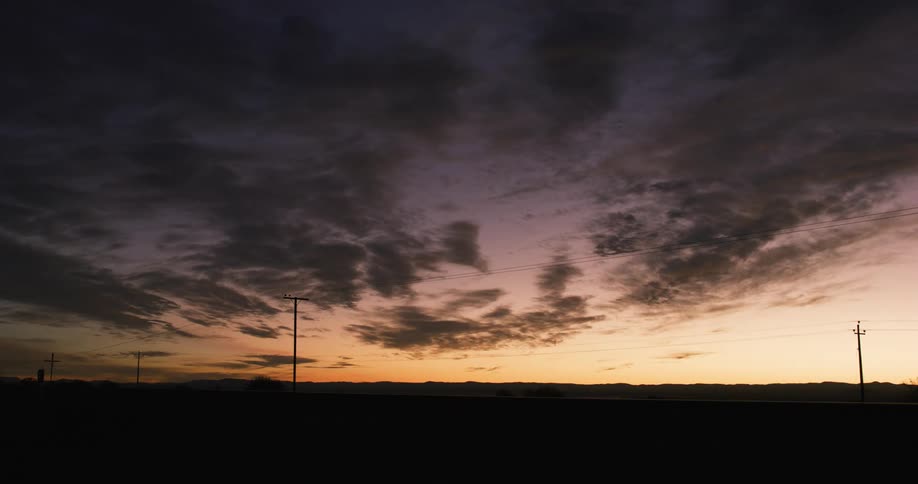 Power lines stretch along a road