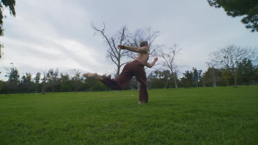A man is doing yoga outside