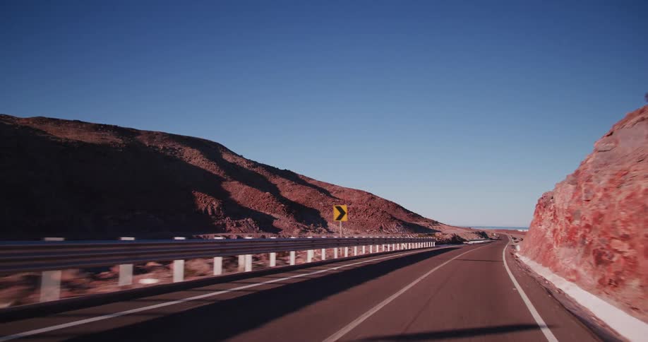 A road cuts through a mountain valley